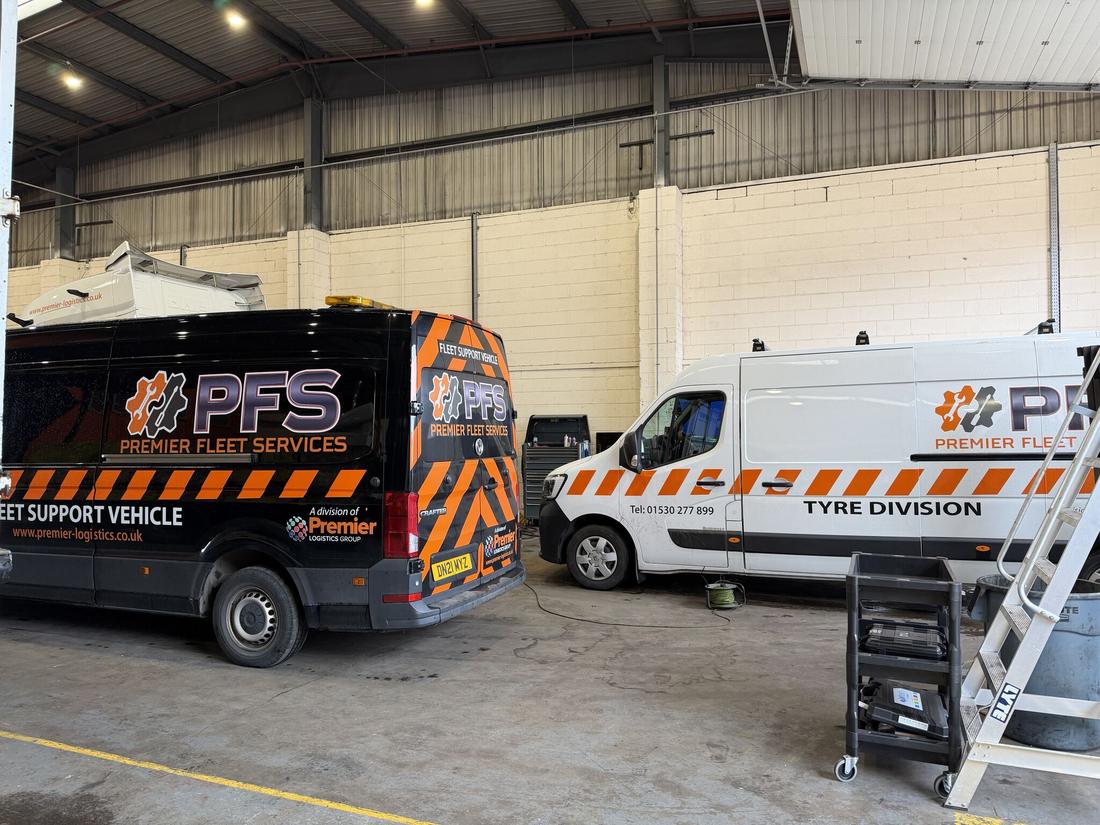 PFS Fleet Support and Tyre Division vans parked together in the workshop
