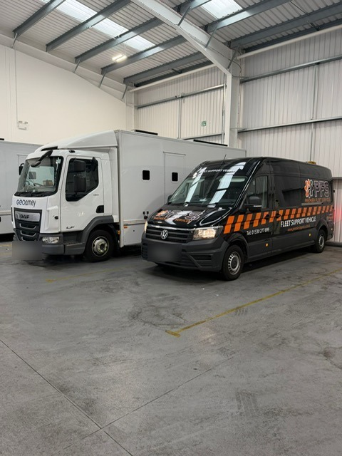 PFS Fleet Support Vehicle parked beside a client truck in the workshop