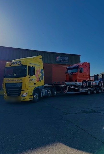 PFS low loader outside the Bardon workshop, loaded with a Scania cab